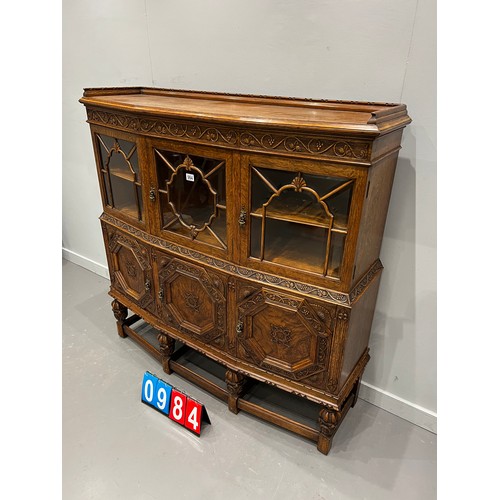 984 - Quality antique oak carved astral glazed cabinet on pineapple leg good colour