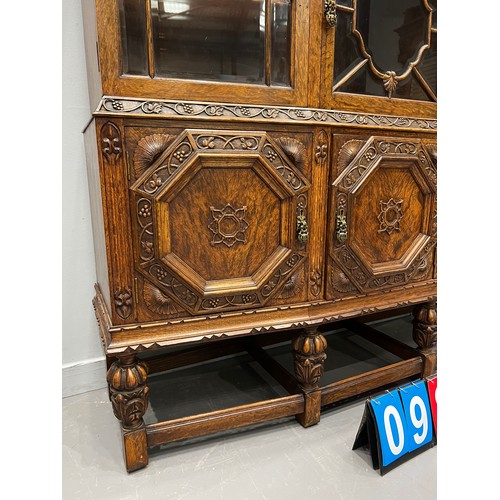 984 - Quality antique oak carved astral glazed cabinet on pineapple leg good colour