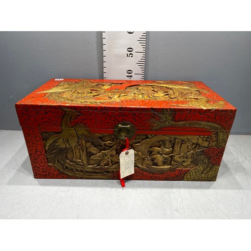 693 - Oriental red laquer camphor wood chest well carved