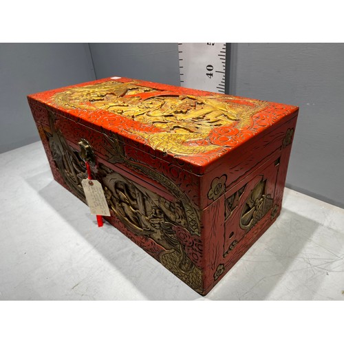 693 - Oriental red laquer camphor wood chest well carved