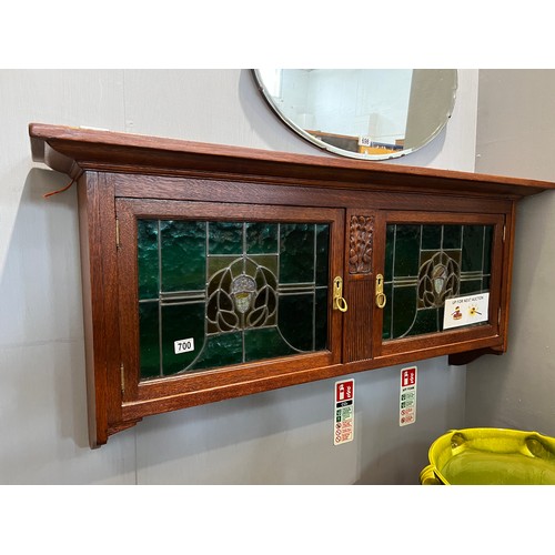 700 - Art nouveau oak wall cupboard with leaded glass double doors