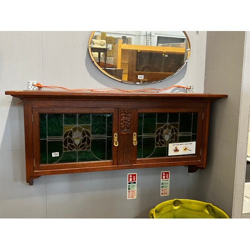 700 - Art nouveau oak wall cupboard with leaded glass double doors