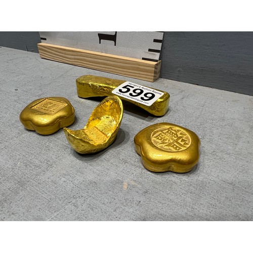 599 - 4 Gold coloured scroll weights