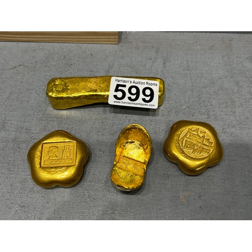 599 - 4 Gold coloured scroll weights