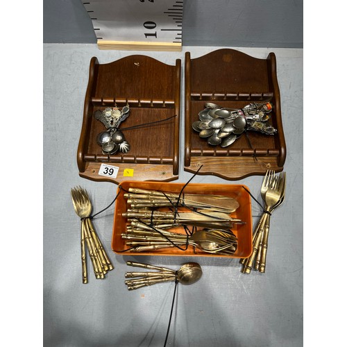 39 - Fifty four pieces bronze cutlery with bamboo design handles + souvenir spoons & racks