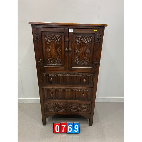 769 - 20thC OAK carved fronted cupboard over 3 drawers