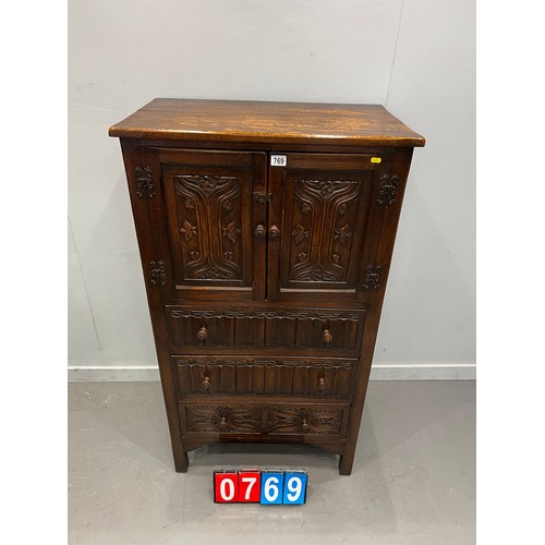 769 - 20thC OAK carved fronted cupboard over 3 drawers