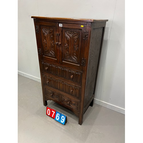 769 - 20thC OAK carved fronted cupboard over 3 drawers