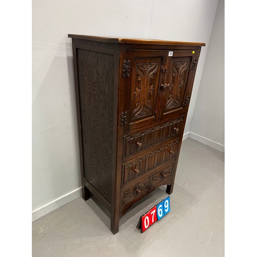 769 - 20thC OAK carved fronted cupboard over 3 drawers