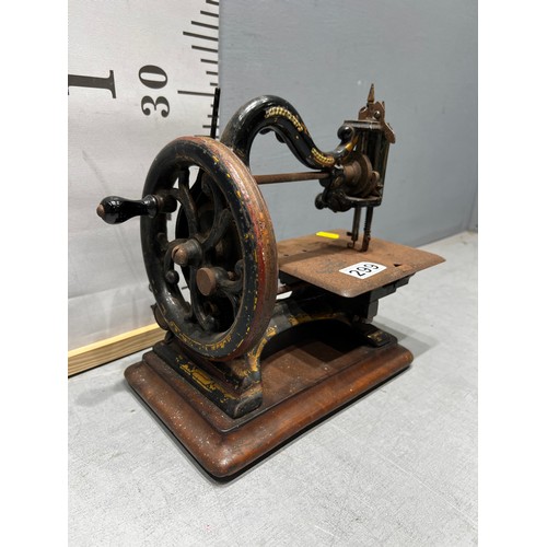 299 - Victorian miniature sewing machine with original label