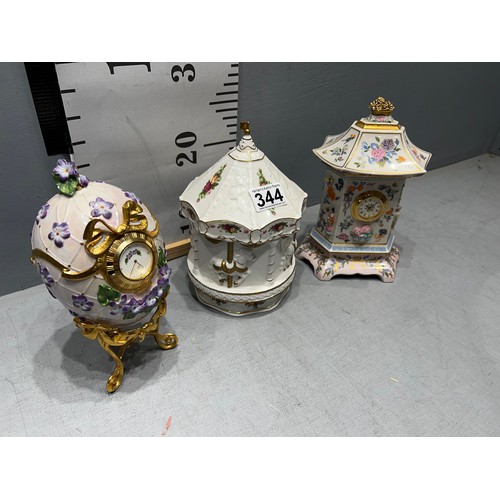 344 - Musical royal Albert carousel + egg on stand, clock + oriental clock