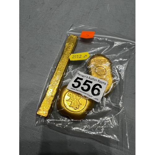 556 - 3 gold coloured scroll weights