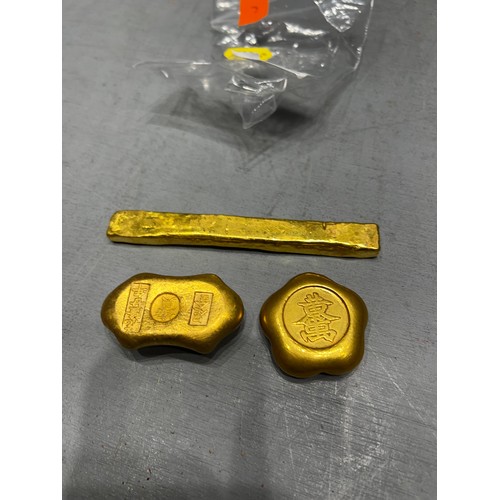 556 - 3 gold coloured scroll weights