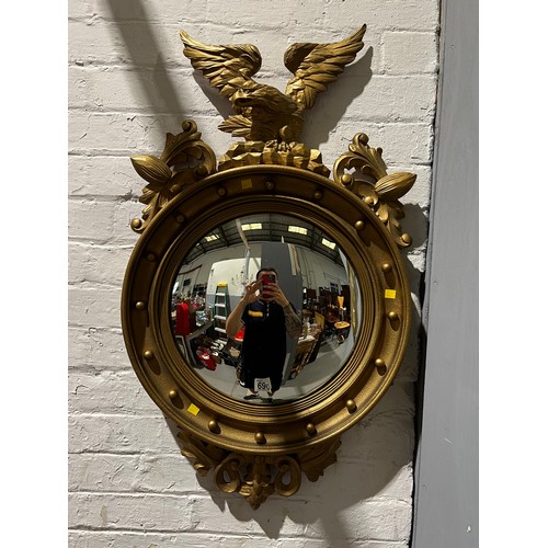 690 - Round gilt mirror with Eagle on top