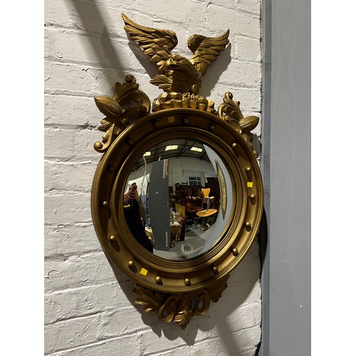 690 - Round gilt mirror with Eagle on top