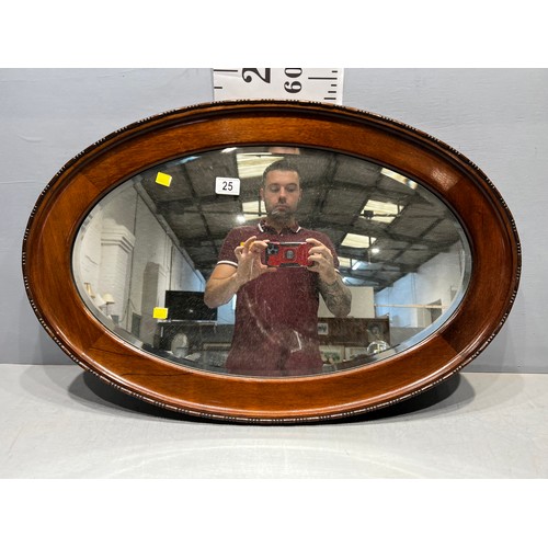 25 - Oval edwardian mahogany framed beveled edge mirror