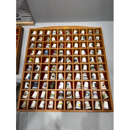 99 - Large quantity china thimbles in cabinet + china bells