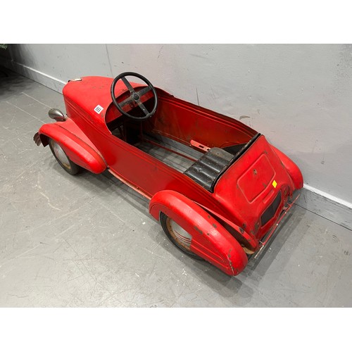 Vintage enamel fairground pedal car