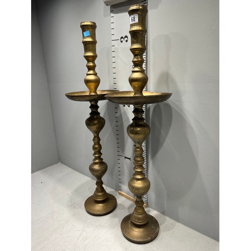 68 - Pair of tall heavy brass candle stand