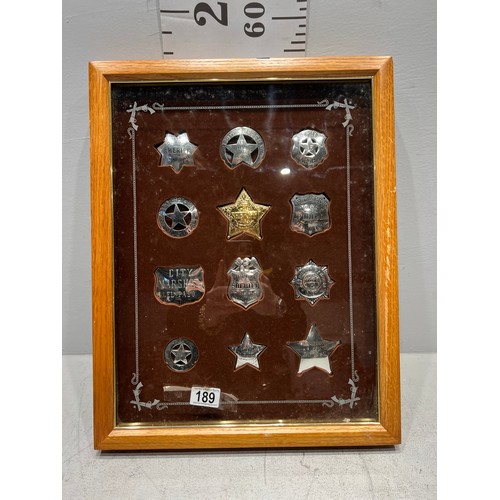 189 - Collection of american sheriff badges etc in display case