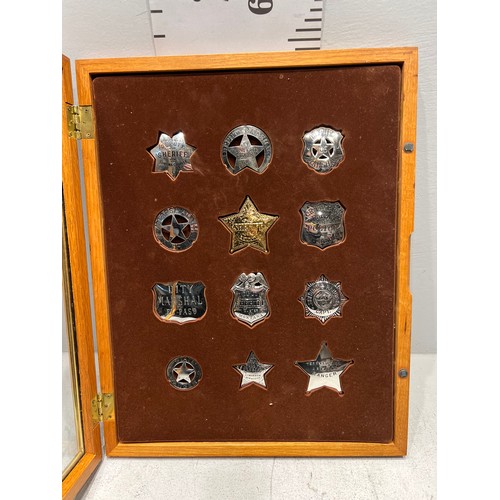 189 - Collection of american sheriff badges etc in display case