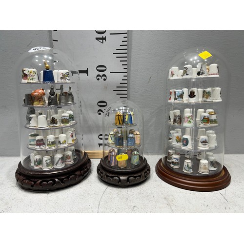 407 - 3 Glass domes with china thimbles