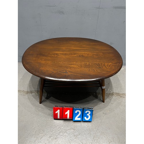 1123 - Circular mid century ercol coffee table with magazine rack