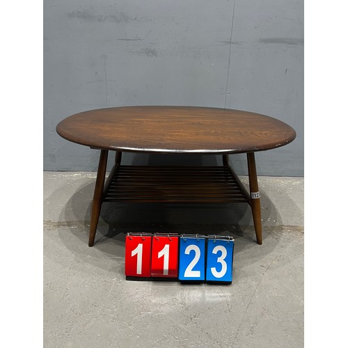 1123 - Circular mid century ercol coffee table with magazine rack