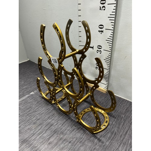 130 - Brass horse shoe wine rack