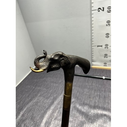 93 - 2 Walking sticks one having brass elephants head handle