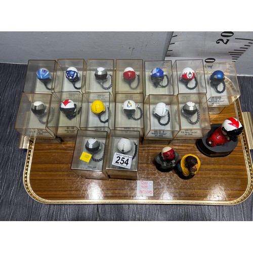 254 - Approx 33 airforce, marines red arrows helmets in display cases