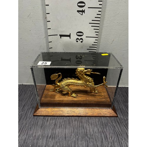 25 - Gilt dragon in glass case