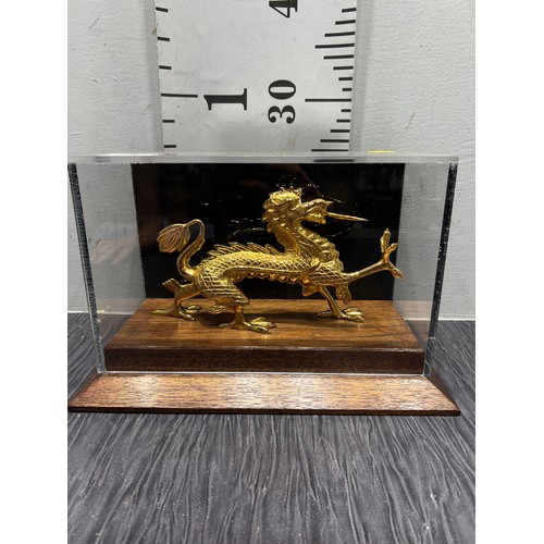 25 - Gilt dragon in glass case