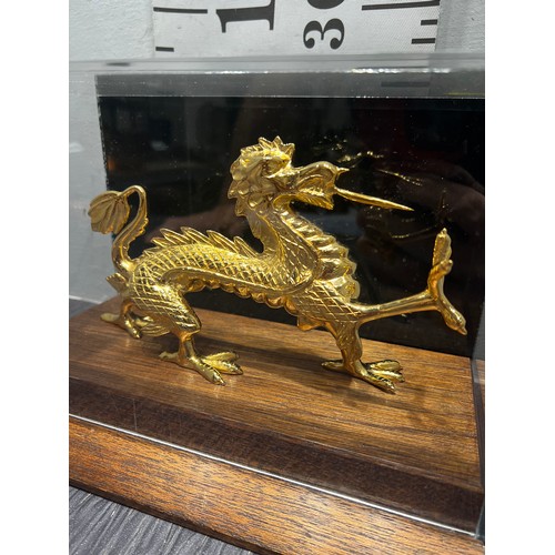 25 - Gilt dragon in glass case