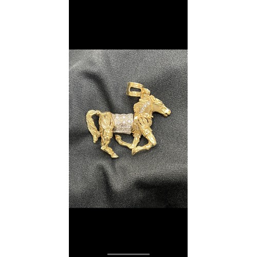 465U - 9ct Gold articulated horse pendant 58.8g gross