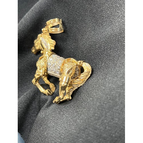 465U - 9ct Gold articulated horse pendant 58.8g gross