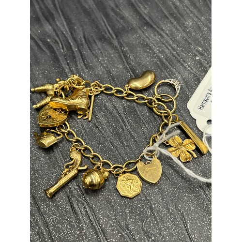 492 - 9ct Gold Charm Braclet with 13 charms 22.8g