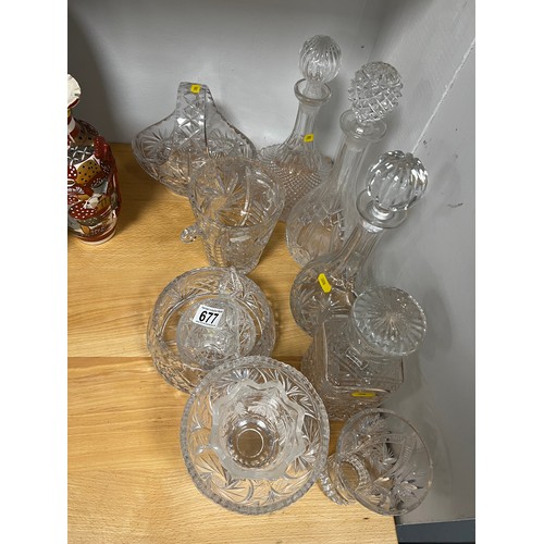 677 - 12 pieces cut glass decanters,vase,ice bucket,bowls etc