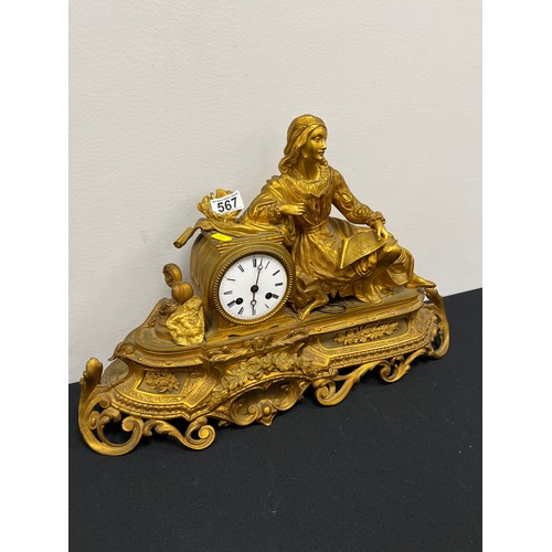 567 - Gilt clock with figure on stand with key