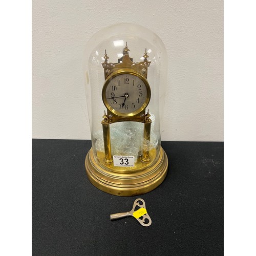 33 - Vintage brass aniversary clock under glass dome with key