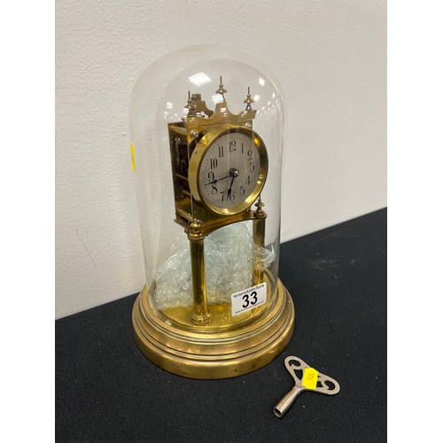 33 - Vintage brass aniversary clock under glass dome with key