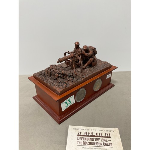 33 - Danbury mint “ Defending the line - The machine gun corps” bronze effect sculpture on a wooden plint... 