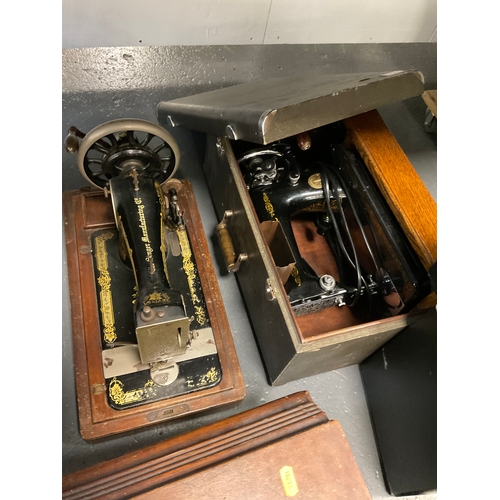 648 - Three vintage singer sewing machines all in original cases
