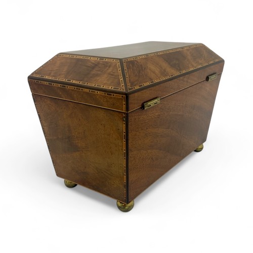 218 - A late Regency cross banded sarcophogus shaped tea caddy. Each of the panels is edged with four colo... 