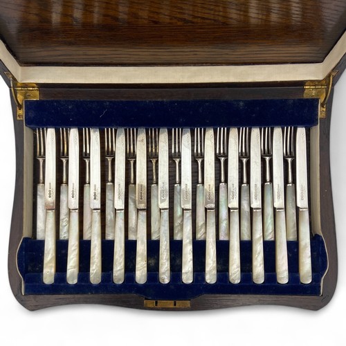 129 - A set of twelve 1930s Art Deco silver bladed dessert fruit knives or forks, with faux mother of pear... 