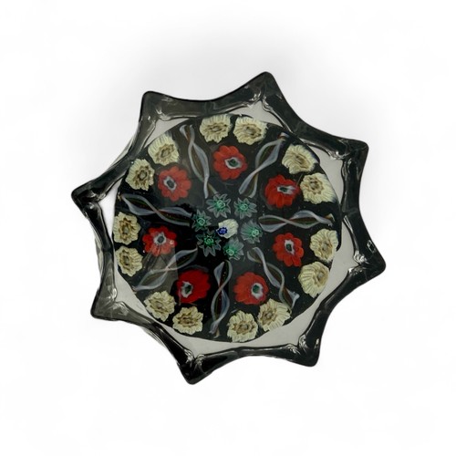 73 - Five medium Strathearn seven spoke radial star moulded millefiori paperweights, with black, pink and... 