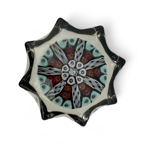 73 - Five medium Strathearn seven spoke radial star moulded millefiori paperweights, with black, pink and... 