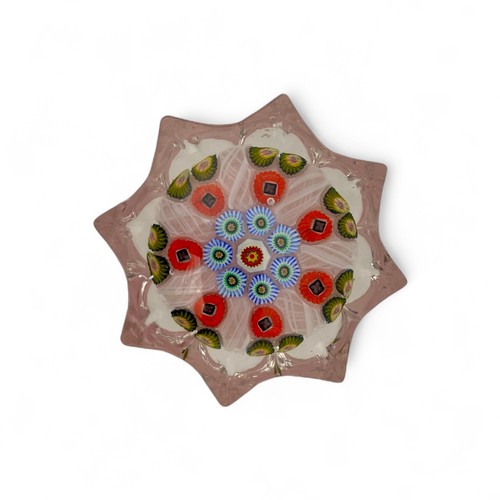 73 - Five medium Strathearn seven spoke radial star moulded millefiori paperweights, with black, pink and... 