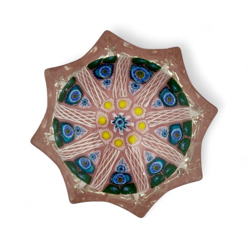 66 - Two large Strathearn nine spoke radial millefiori star moulded paperweights, with blue and yellow gr... 