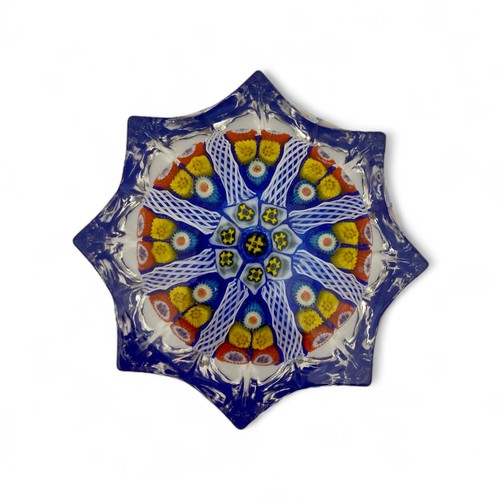 67 - Two large Strathearn eight spoke radial star moulded millefiori paperweights, with blue and yellow g... 